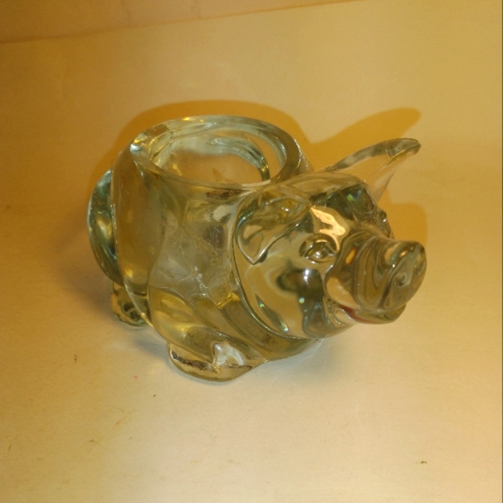 Vintage clear glass Candle holder is a cute piggy.